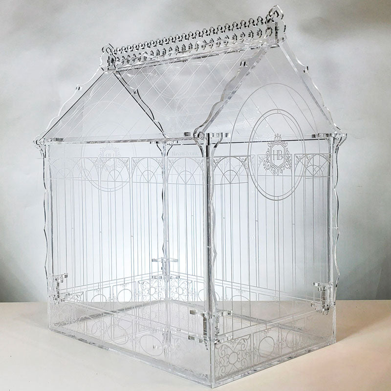 Close-up of the intricate engraving and cutwork details on a Victorian-style terrarium, showcasing fine craftsmanship and ornate design.