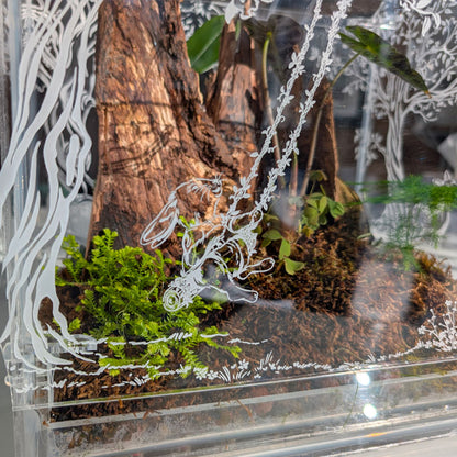 Close-up of the intricate engraving of a rabbit swinging inside the Victorian-style terrarium, showcasing detailed craftsmanship.