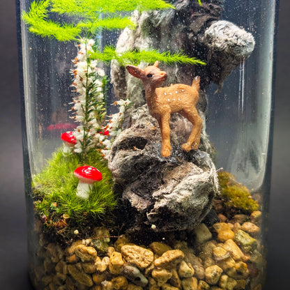 Glass vase mossarium with clear acrylic lid, featuring moss, mushrooms, and a small deer in a magical fairy tale scene